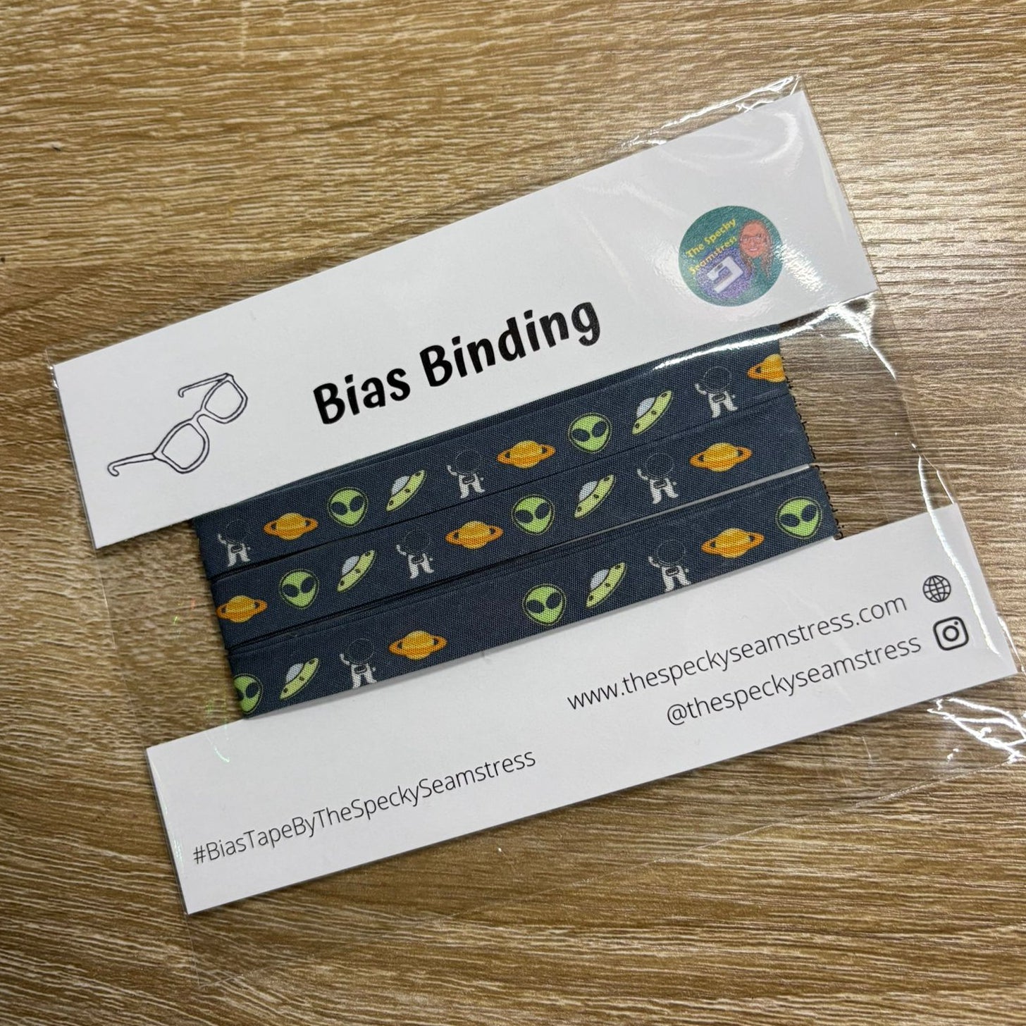 Aliens Slate bias in packaging on a wooden background. 