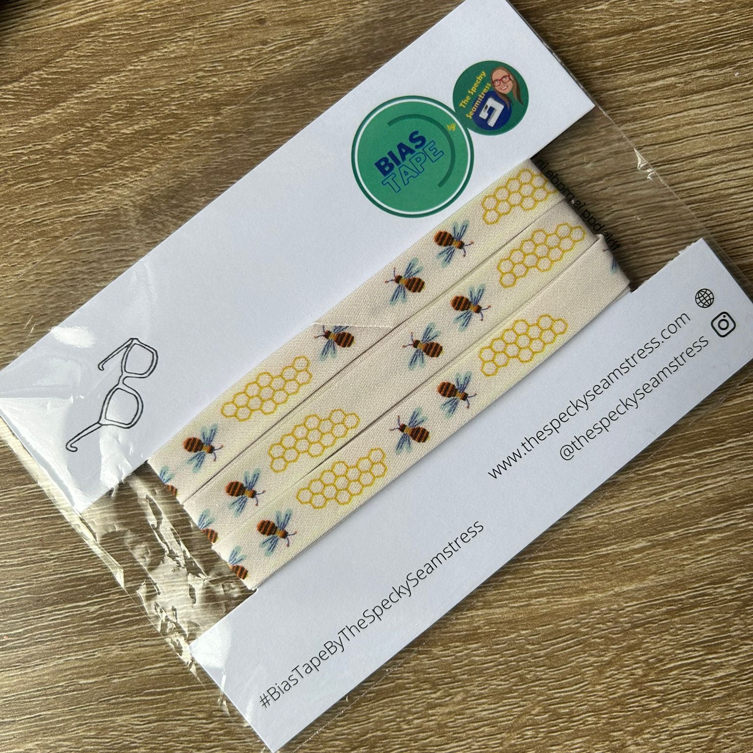 Bees bias on a white card, on a wooden background. 