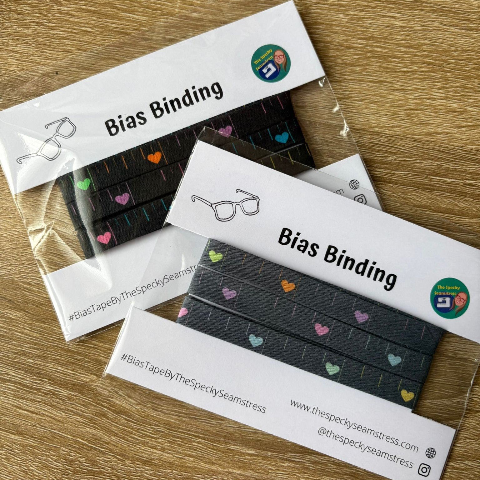 Disco Tape Bias and Disco Tape Slate Bias  binding strips in clear packaging on a wooden surface
