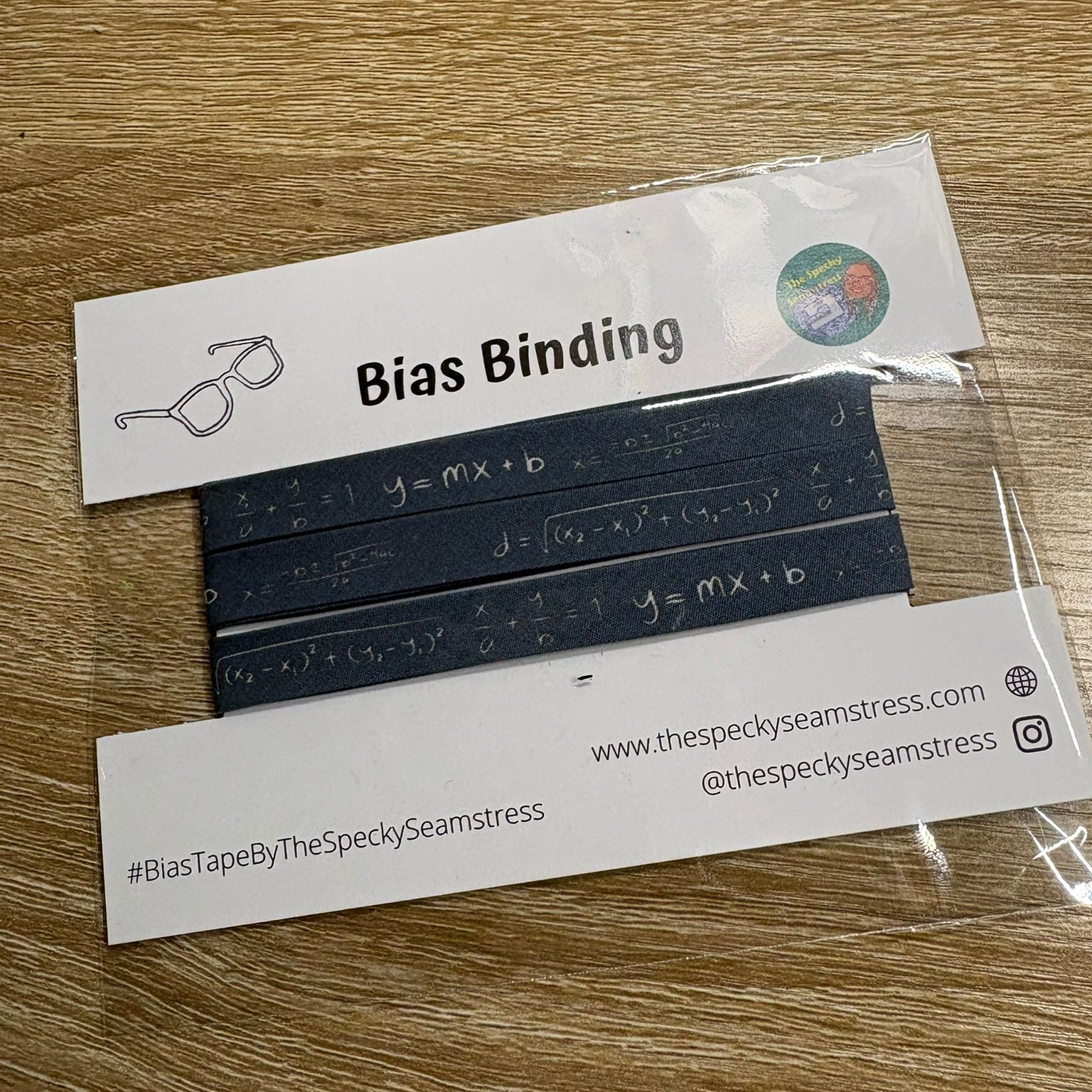 Maths Slate bias in packaging on a wooden background. 