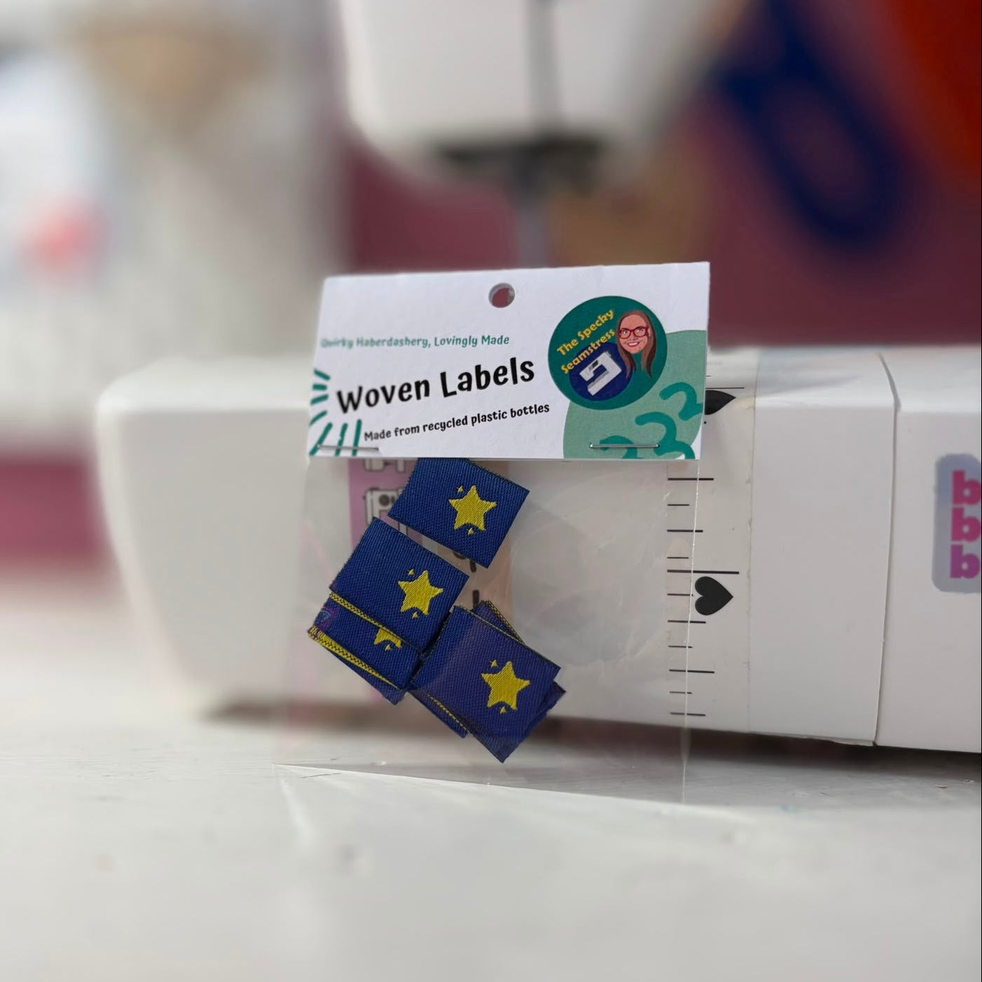 8 Mini Star labels in a clear bag with a white header card, photographed in front of a sewing machine.