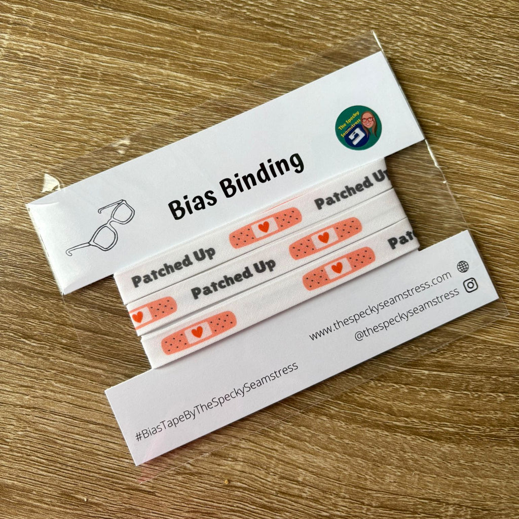 White bias with plaster motif on a white backing card, placed on a wooden background.