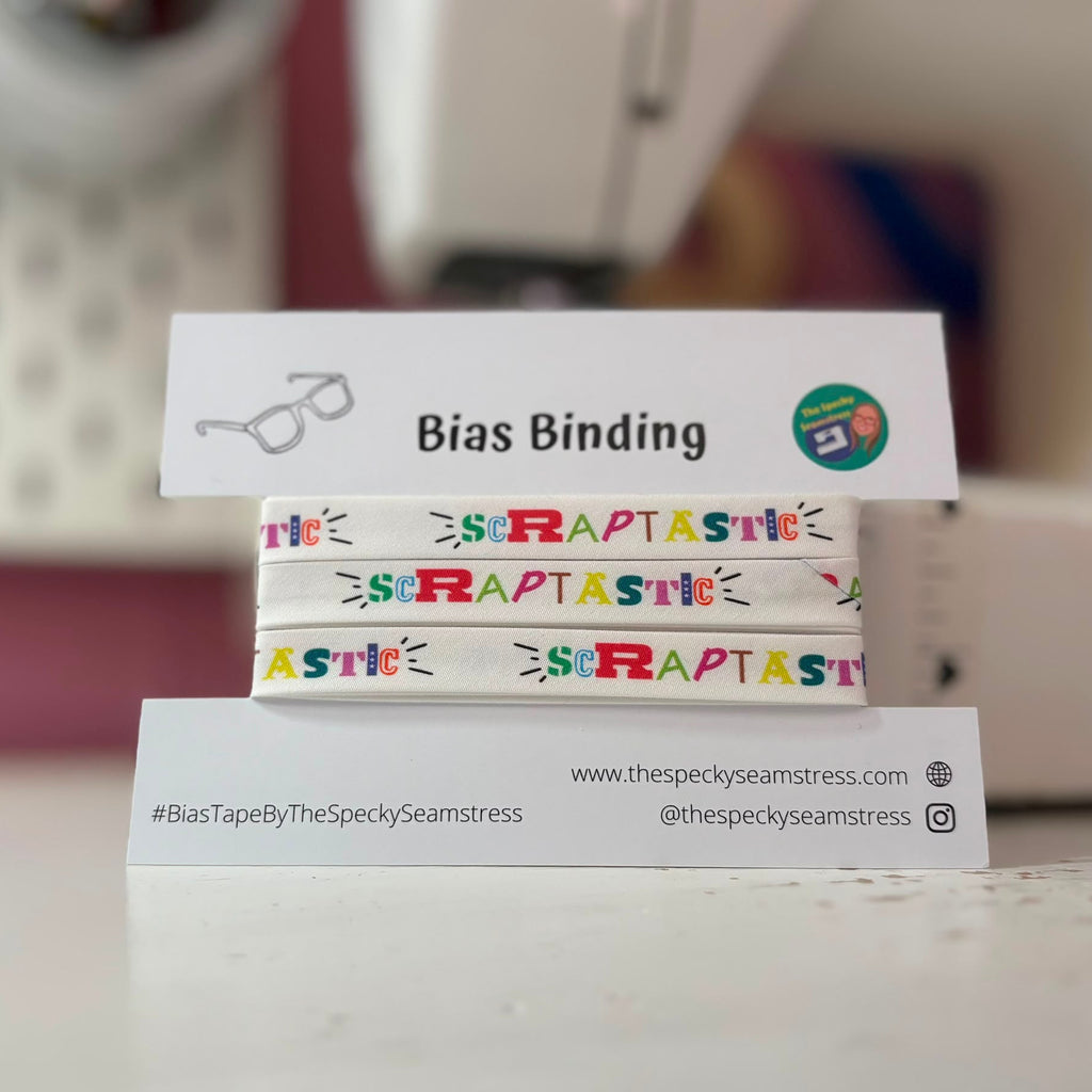 A pack of colourful 'Scrapastic' bias binding tapes on a white card with branding text.