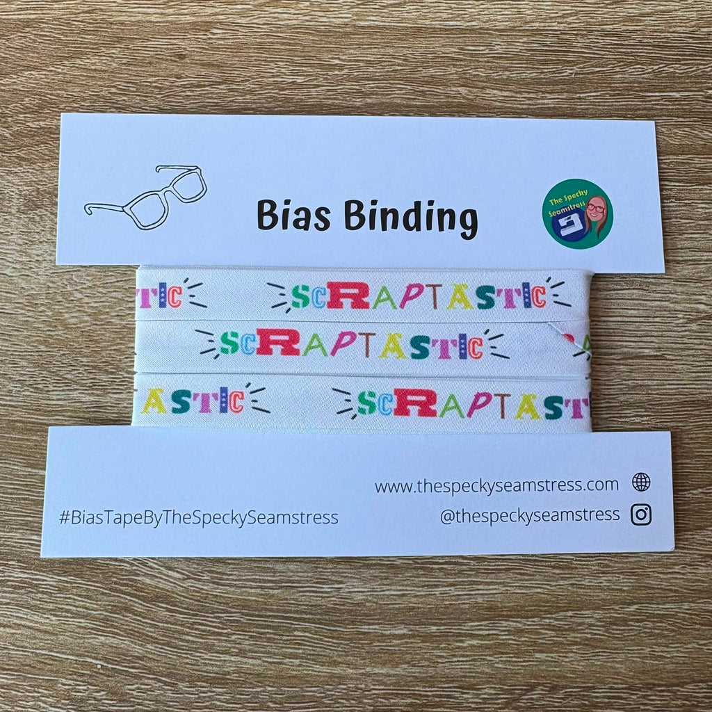 Bias binding tape on a white card with branding on a wooden surface.