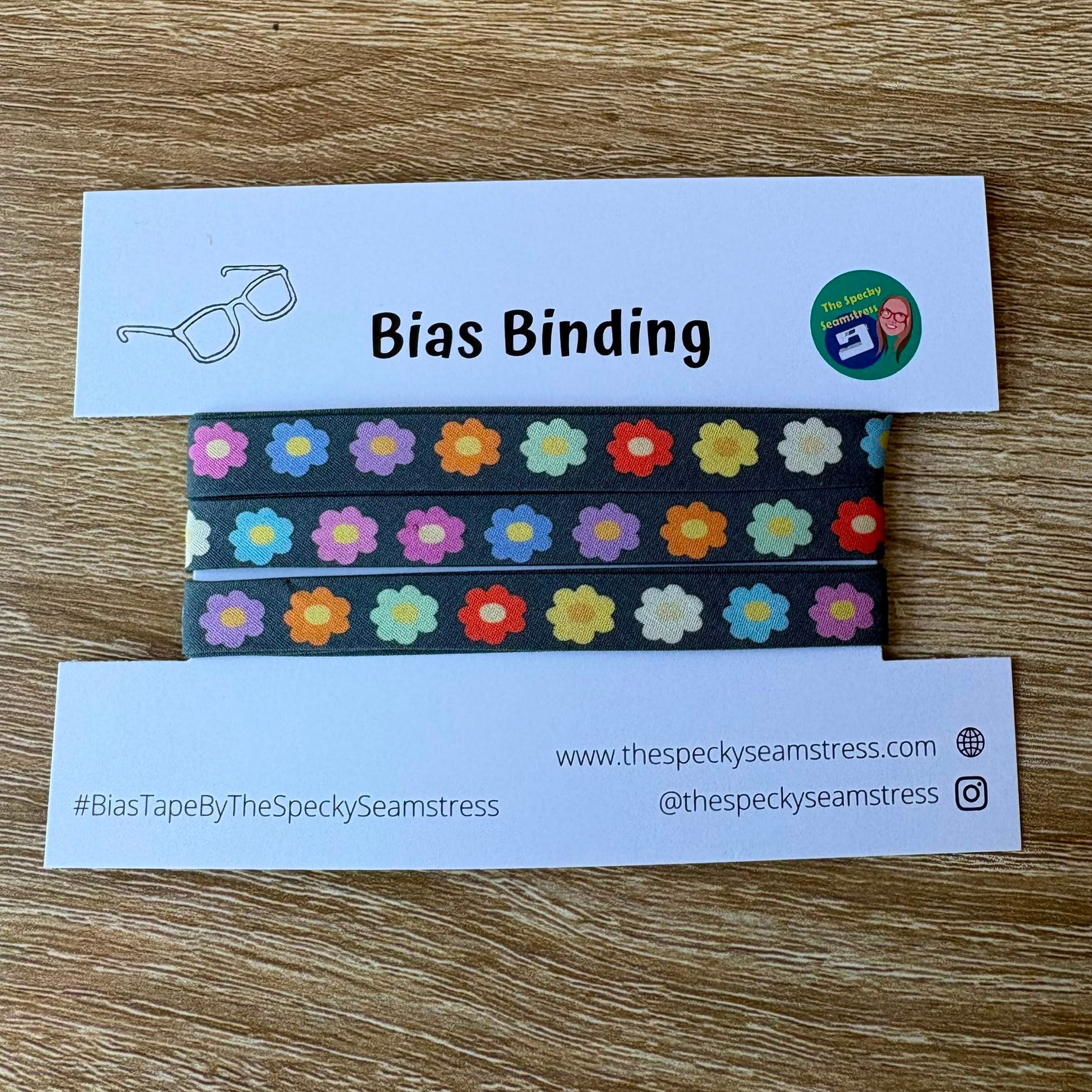 Bias binding tape with floral pattern on a wooden surface