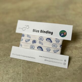 Blue and White Shells Bias wrapped around a white card on a cream background.