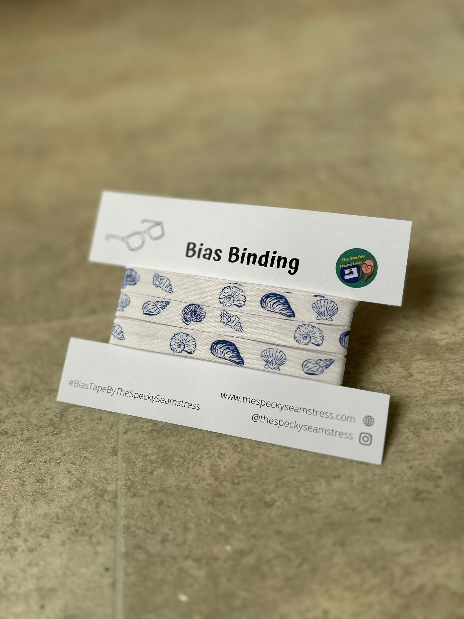Blue and White Shells Bias wrapped around a white card on a cream background.