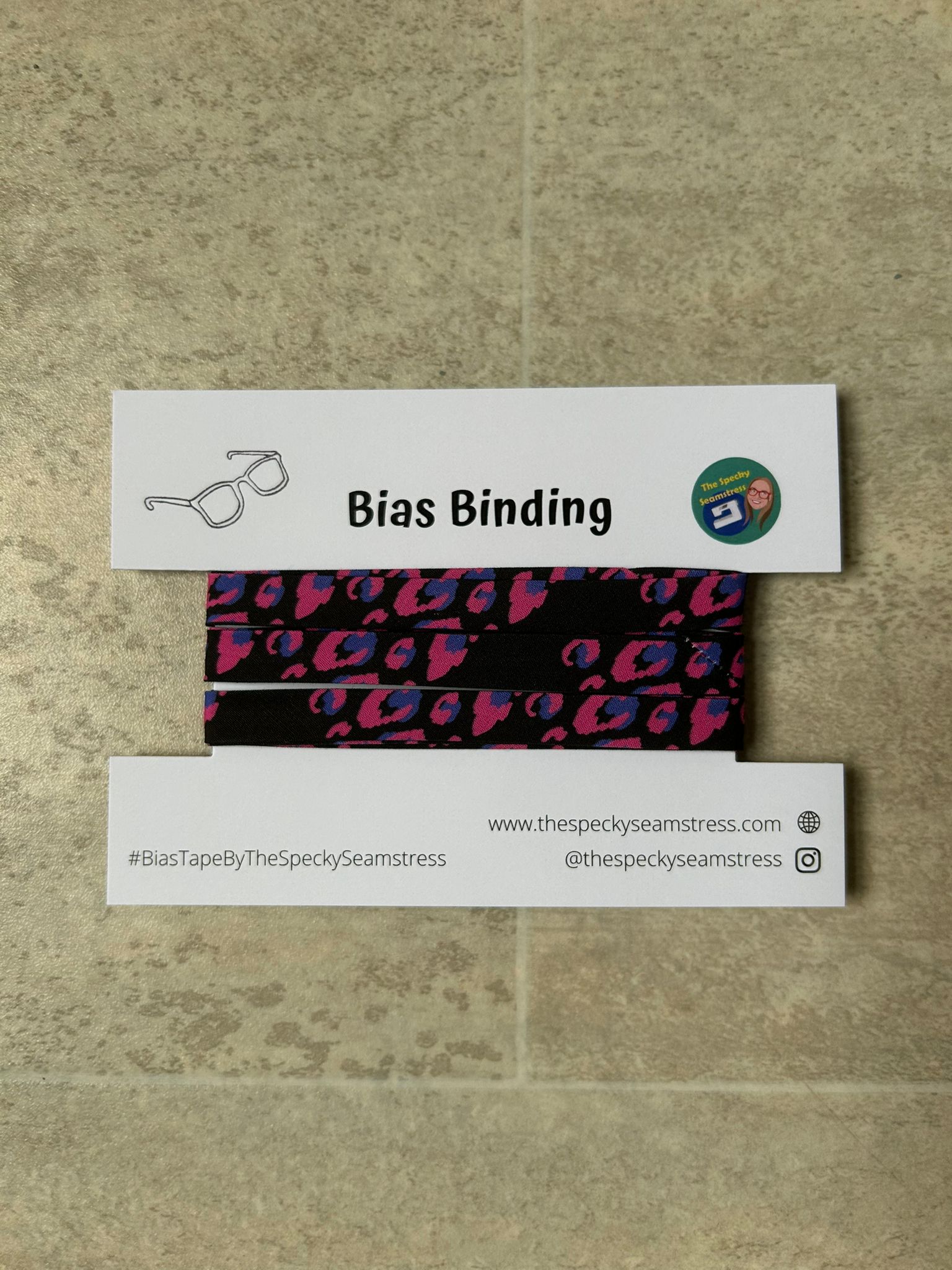 Pink Leopard bias wrapped around a white display card on a cream background.
